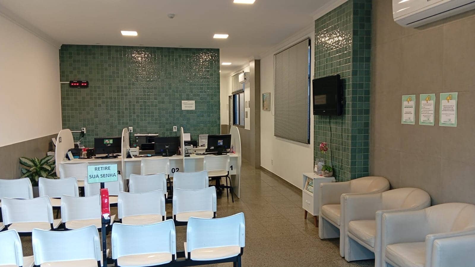 Recepção do Laboratório Santa Teresa, com guichês de atendimento e sala de espera.